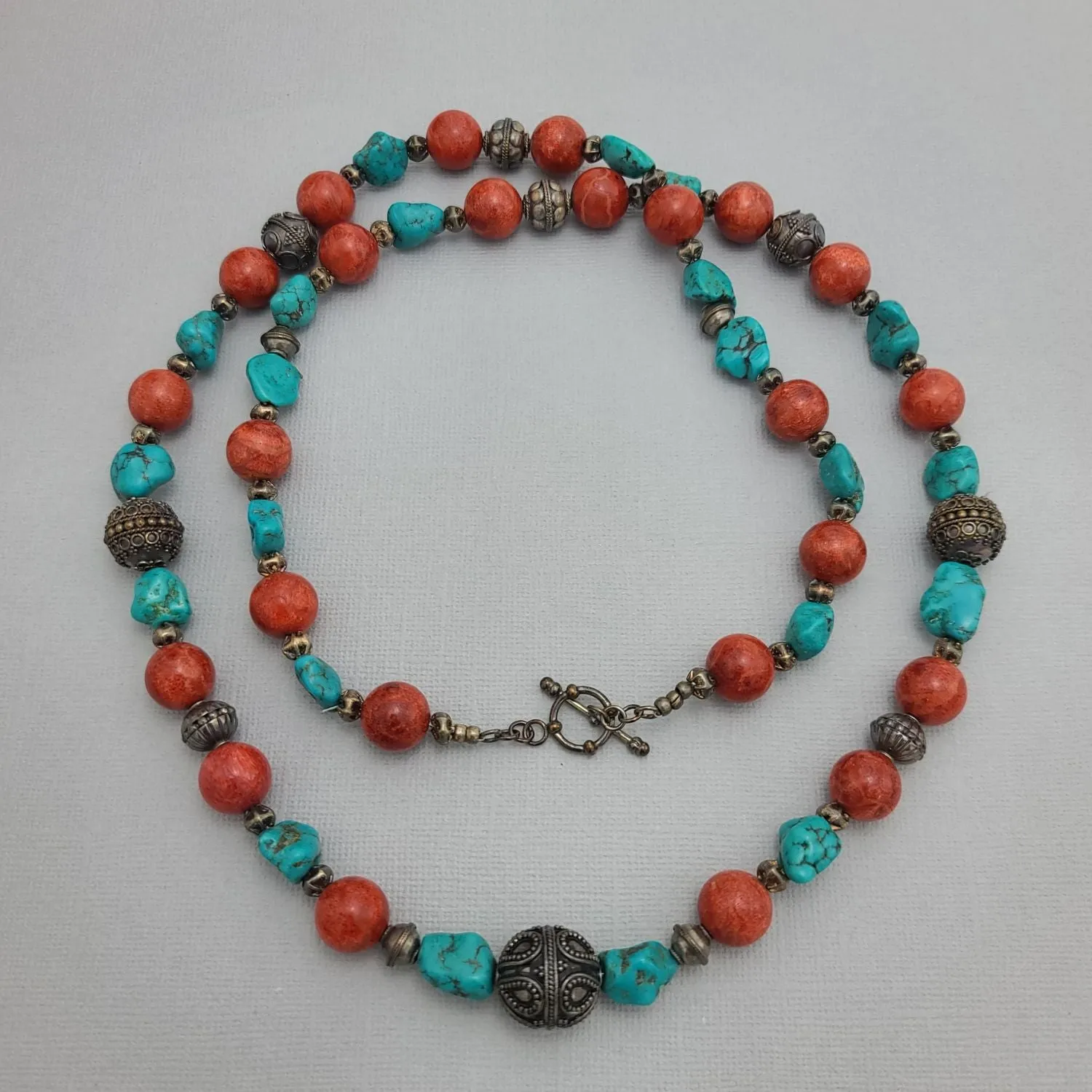 Stylish Beaded Necklace with Turquoise, Coral, and Antique Sterling Silver Beads.
